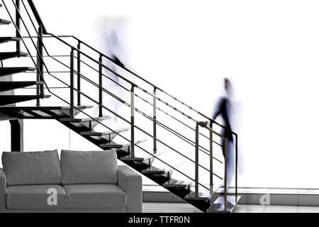 Modern stairs in office and blurred silhouettes of moving people Stock Photo