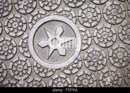 A fragment of a metal plate with a pronounced geometric pattern Stock Photo