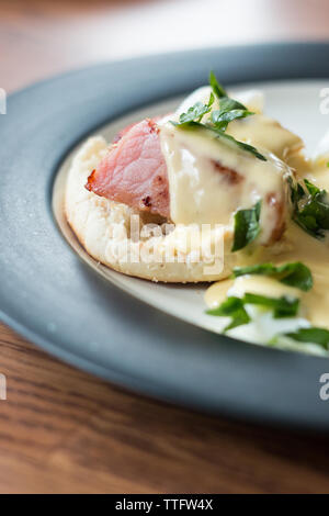 Plated Eggs Benedict Close-up with Hollandaise sauce Stock Photo