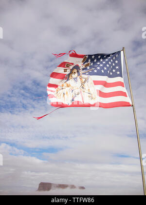 A tattered American flag depicting an Indian blows in the wind. Stock Photo