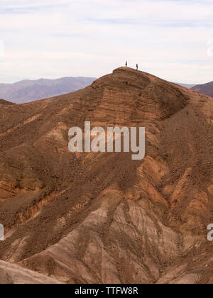 Two figures on a ridge in Death Valley. Stock Photo