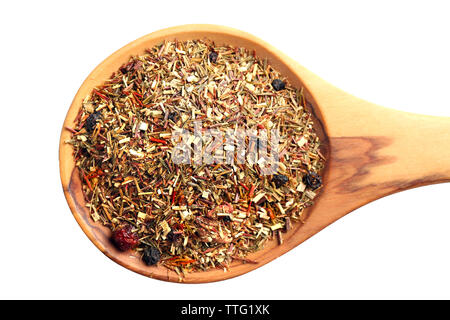 Mix of dry tea with berries in wooden spoon, isolated on white Stock Photo