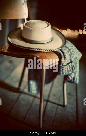 Close-up of hat and sweater on chair Stock Photo