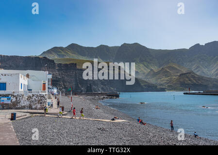 PUERTO DE LAS NIEVES, GRAN CANARIA, SPAIN - MARCH 11, 2019: People on the beach against the backdrop of a mountain landscape. Copy space for text. Stock Photo