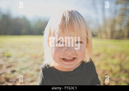 Portrait of a young girl smiling outdoors