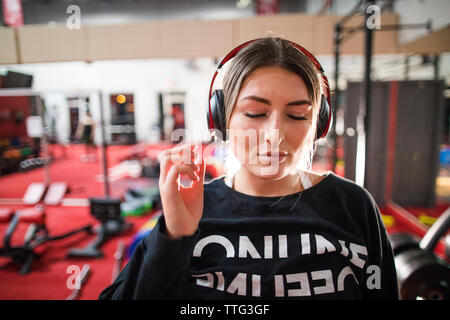 Attractive woman listening to music during a workout at the gym. Stock Photo