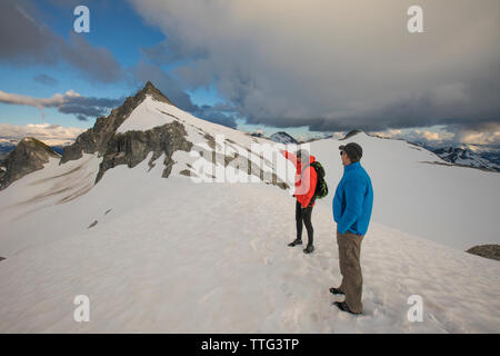 Two mountaineers plan their route to summit of Cypress Peak, B.C. Stock Photo