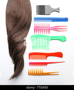 Barber set with strand of hair and different combs, isolated on white Stock Photo