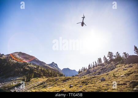 Helicopter flying above Douglas Peak, British Columbia, Canada. Stock Photo
