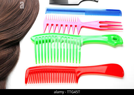 Barber set with strand of hair and different combs, isolated on white Stock Photo