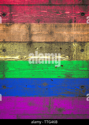 Rainbow colored spectrum gay pride background on textured layered wood grain textured concrete wall Stock Photo