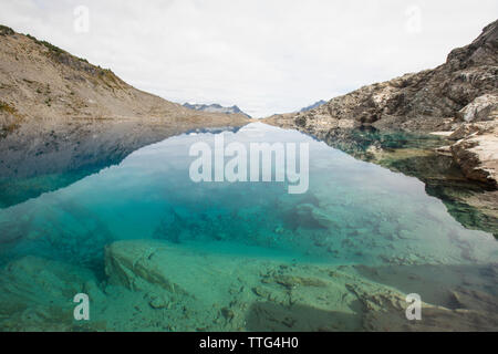 Mountain view reflected in alpine cirque lake, British Columbia. Stock Photo