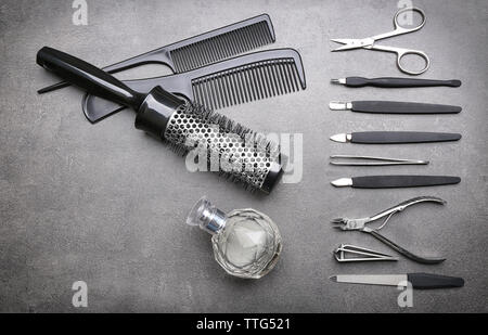 Manicure set with hair comb and perfume on grey background Stock Photo