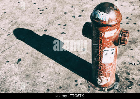 High angle view of old fire hydrant on street during sunny day Stock Photo