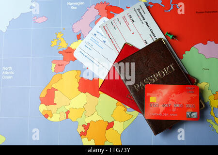 Credit cards with passports and tickets for vacations on the world map background Stock Photo