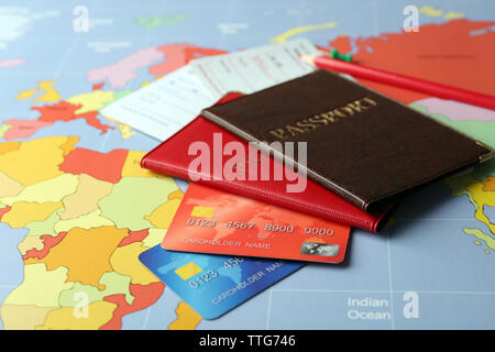 Credit cards with passports and tickets for vacations on the world map background Stock Photo