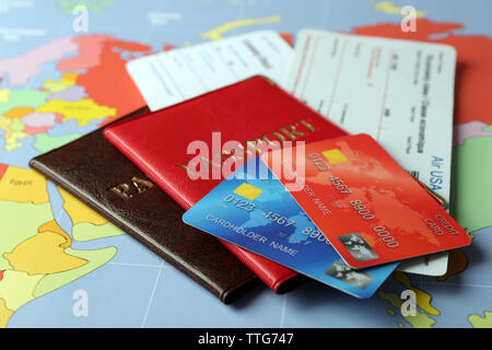 Credit cards with passports and tickets for vacations on the world map background Stock Photo