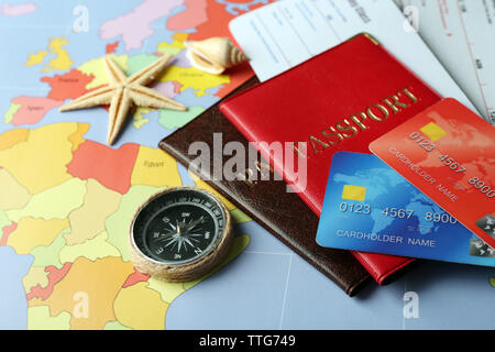 Credit cards with passports and tickets for vacations on the world map background Stock Photo