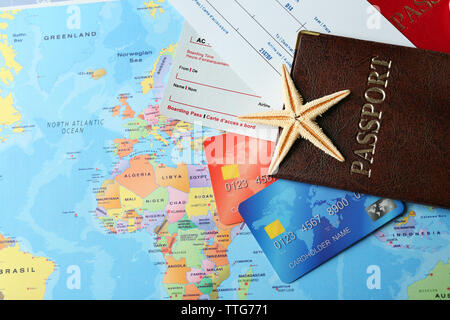 Credit cards with passports and tickets for vacations on the world map background Stock Photo