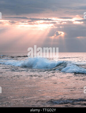 Sun rays and big waves Stock Photo