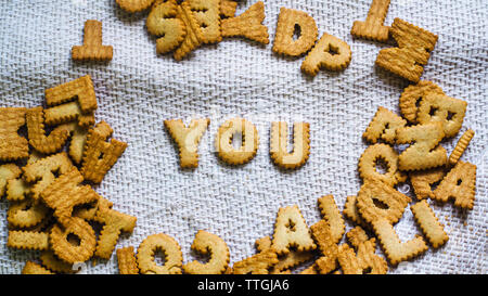 find you concept Cookies in the form of the alphabet prospect .Happy from homemade cookies on dark white background. Happy cookies concept. Stock Photo