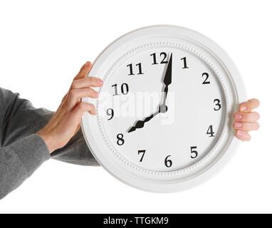 Man hands holding big round clock, isolated on white Stock Photo
