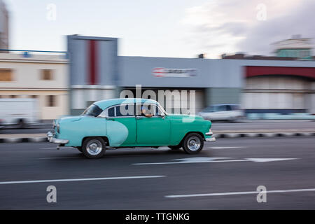 Havana, Cuba, 2017: Vintage car driving in oceanfront street. Malecon Stock Photo
