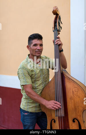 Musician playing on street. Real Life scene in Trinidad, Cuba. 2017. Stock Photo