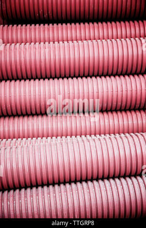 Close-up of red corrugated plastic pipes Stock Photo
