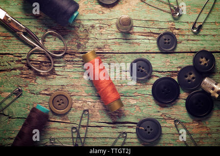 Overhead view of various sewing items on old wooden table Stock Photo