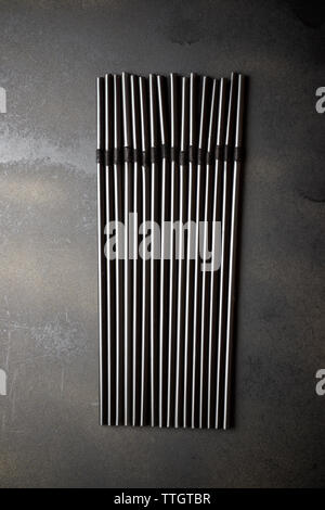 Drinking straws on a black table Stock Photo