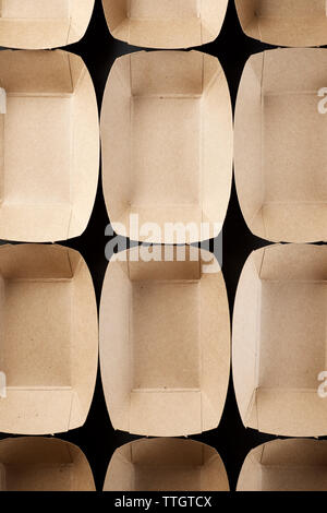 Empty boxes of disposable cardboard to distribute snacks on a black table. Stock Photo