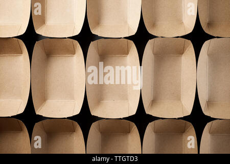 Empty boxes of disposable cardboard to distribute snacks on a black table. Stock Photo