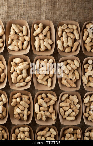 Peanuts with shell in disposable cardboard boxes. Stock Photo