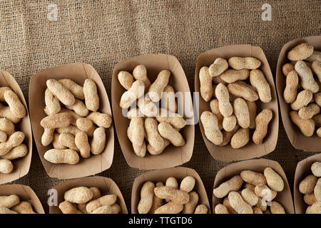 Peanuts with shell in disposable cardboard boxes. Stock Photo
