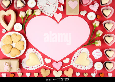 Set of hearts shapes cookies and candies on red table, top view Stock Photo