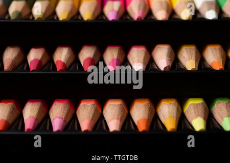 Watercolor pencils lined up in a black plastic box. Stock Photo