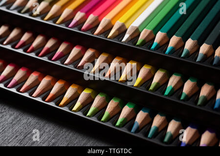 Watercolor pencils lined up in a black plastic box. Stock Photo