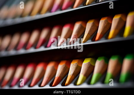 Watercolor pencils lined up in a black plastic box. Stock Photo