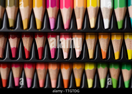 Watercolor pencils lined up in a black plastic box. Stock Photo