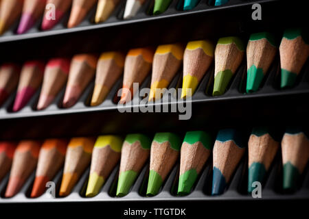 Watercolor pencils lined up in a black plastic box. Stock Photo