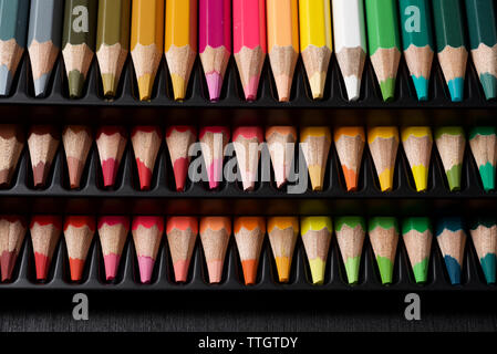Watercolor pencils lined up in a black plastic box. Stock Photo