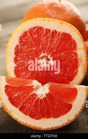 Sliced grapefruits on wooden background, close up Stock Photo