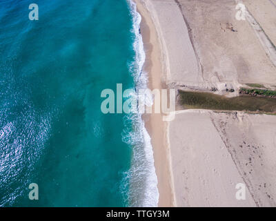 Waves rolling onto sandy beach Stock Photo