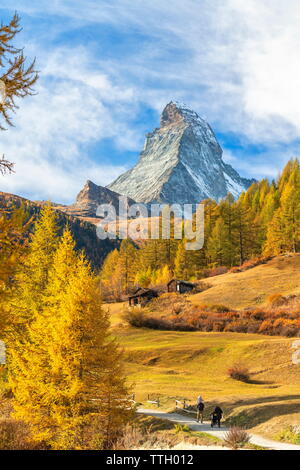 Family walking on path to Matterhorn in autumn, Switzerland Stock Photo