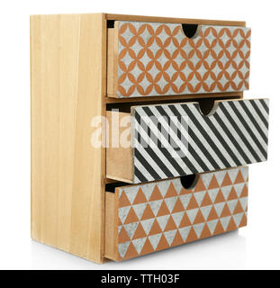 Mini handmade chest of drawers on wooden table background Stock Photo