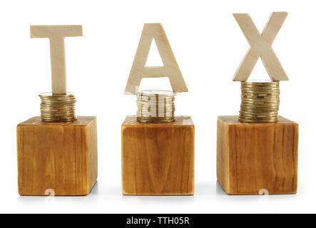 Stacked coins with wooden cubes and word TAX isolated on white Stock Photo