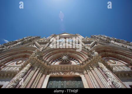 Low angle view of Siena Cathedral against blue sky