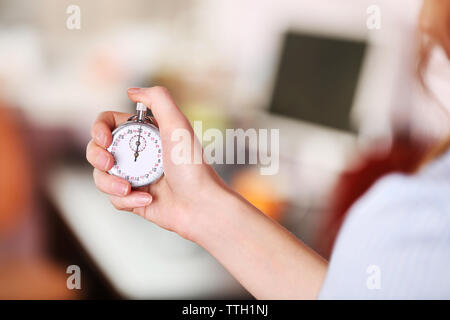 Woman holds stopwatch in hand, close up Stock Photo