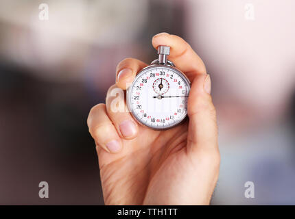 Man holds stopwatch in hand, close up Stock Photo